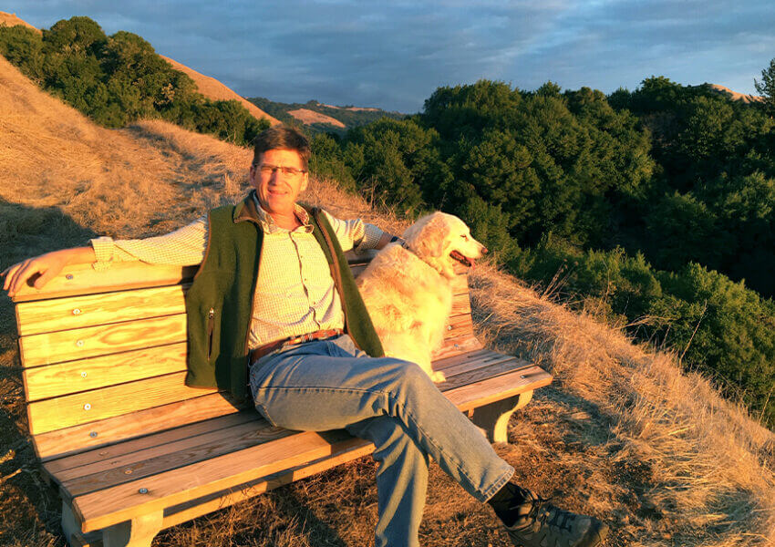 Will Wyman with dog on hillside