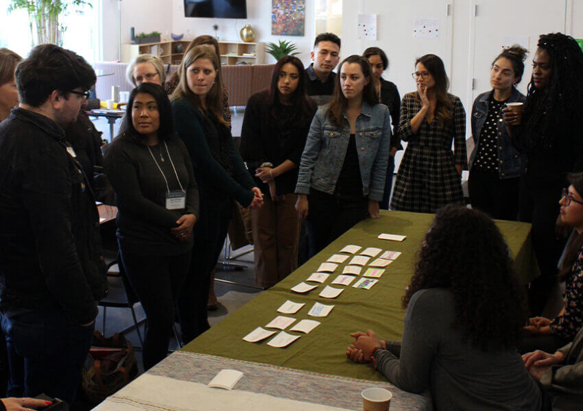 Leadership Academy students standing around a table
