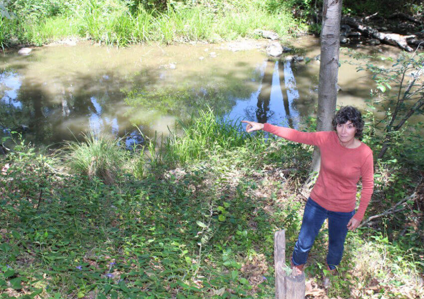 Photo of Pat next to creek