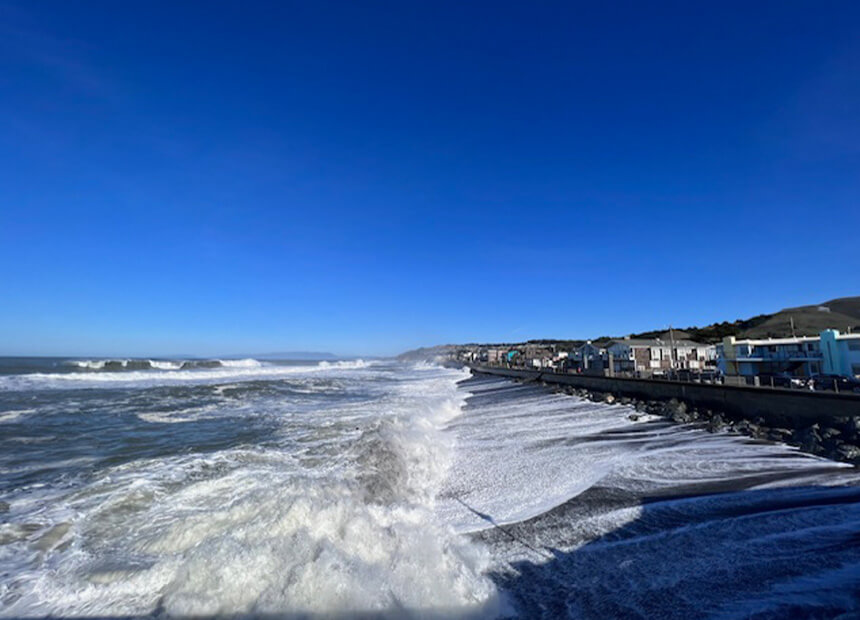 surf crashing against sea wall in Pacifica