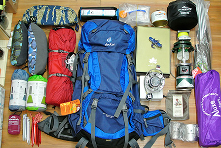 assorted hiking gear laid out on a table