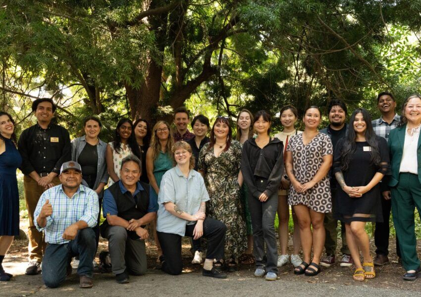 Leadership Program graduates, class of 2025, standing together under trees