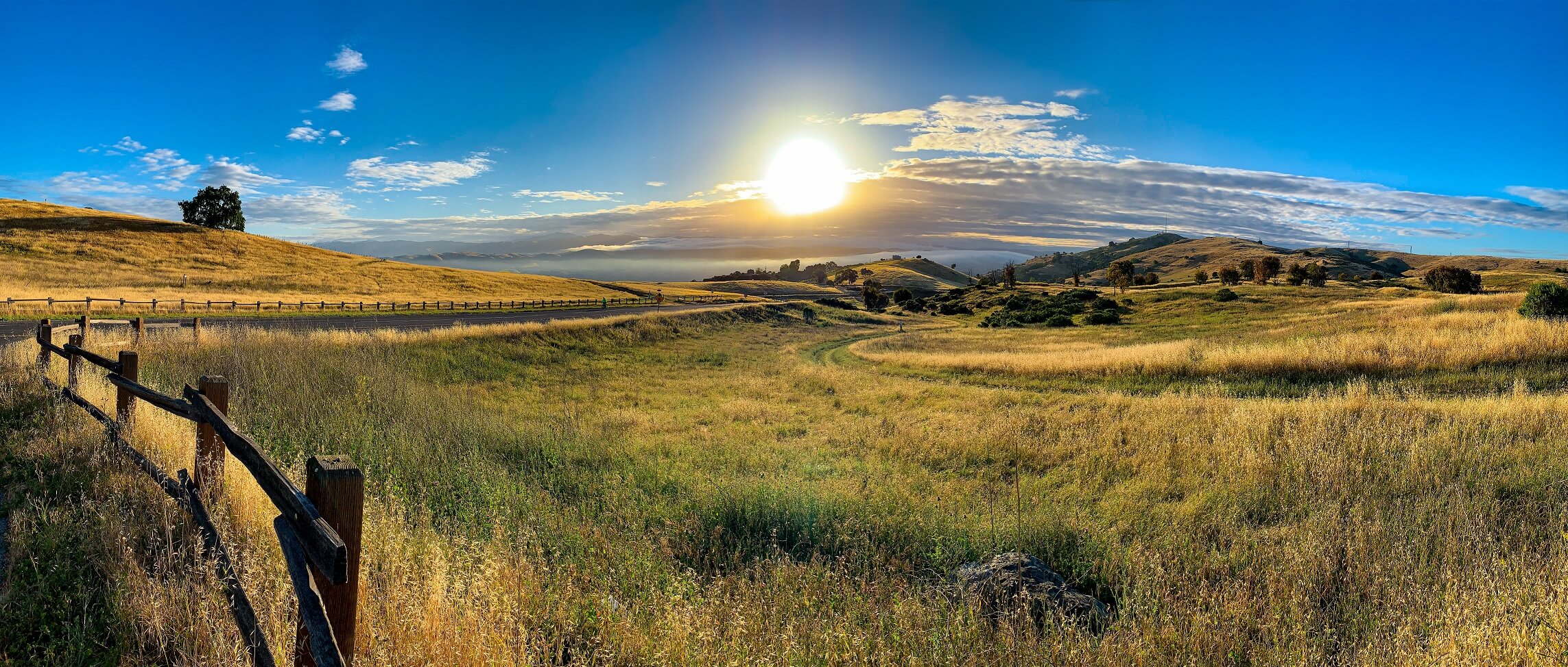 Sun setting over golden hills